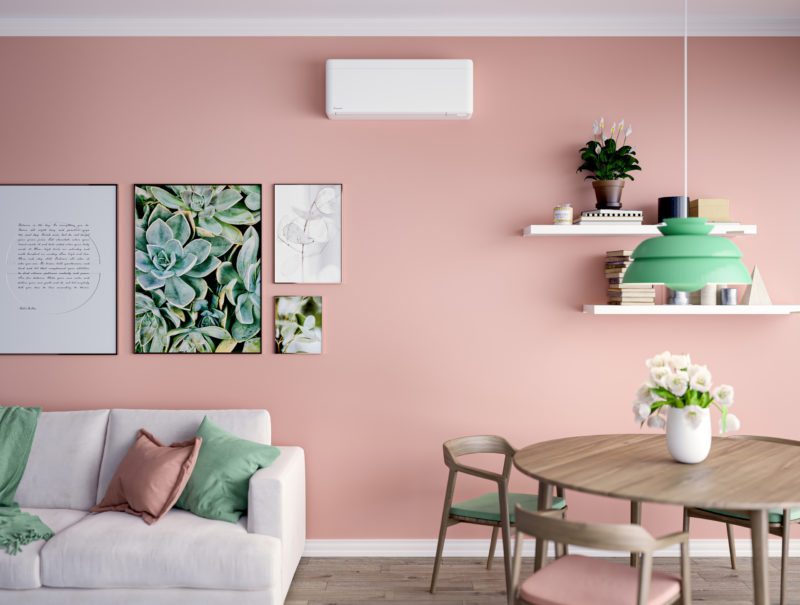 a living room with pink walls and a table and chairs