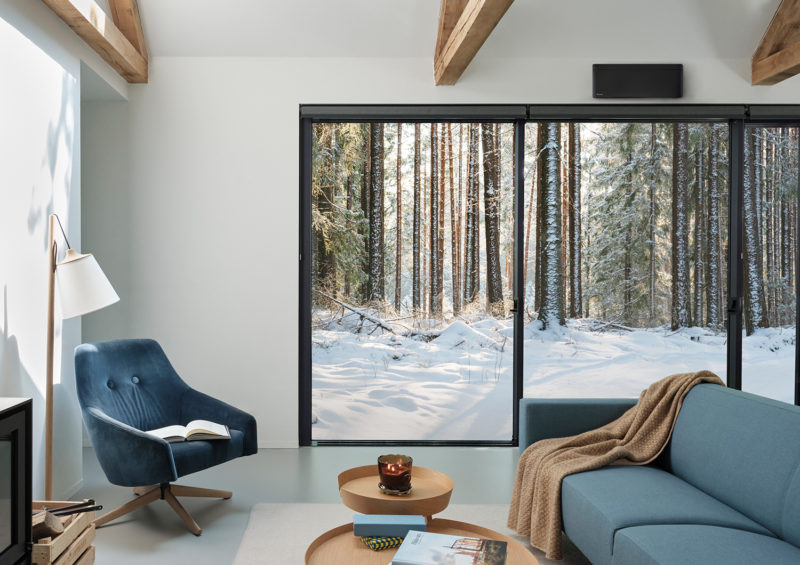 a living room with a view of a snowy forest