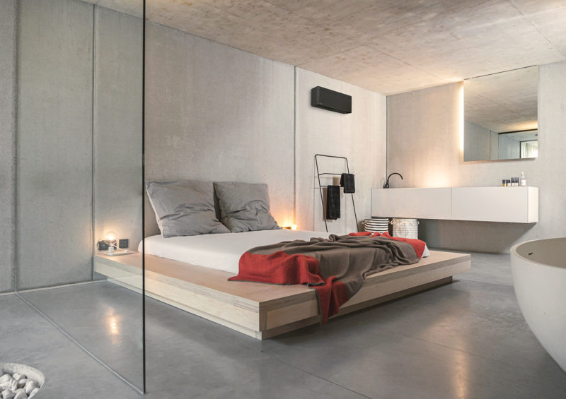 a bed with a glass wall